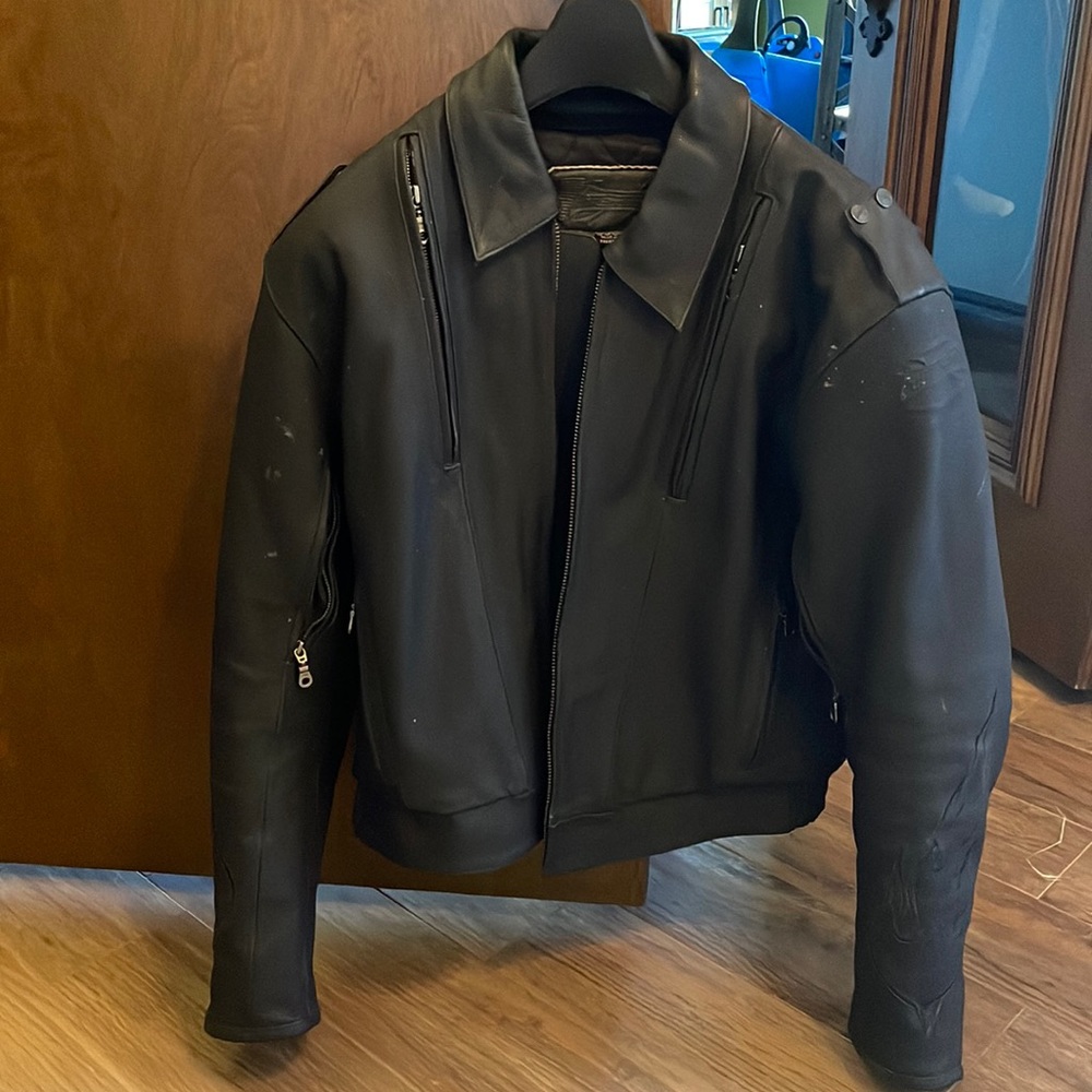 Black, leather motorcycle jacket with shoulder, back and elbow pads